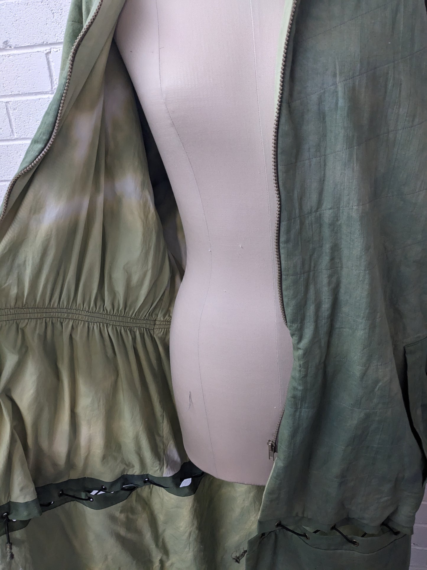 Hand dyed green modular coat on dress form